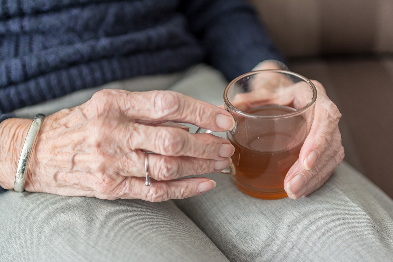 Elderly woman holding a cup of tea