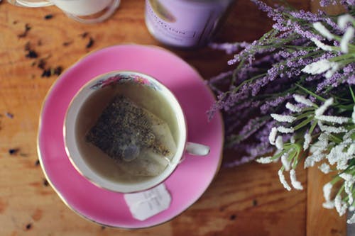 A cup of green tea with pink saucer