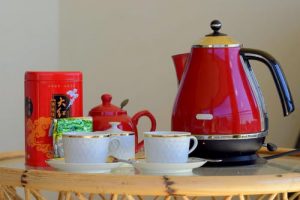 Red electric kettle with tea set