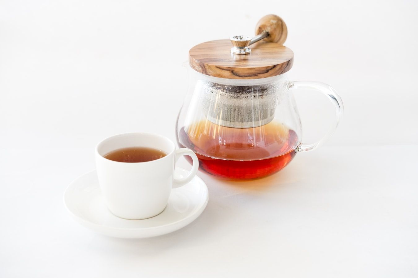 a cup of tea beside a tea diffuser