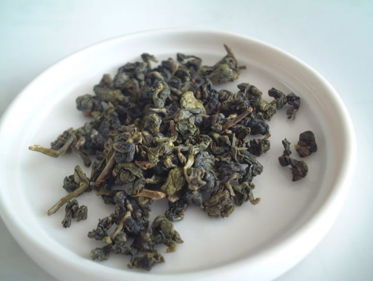 Rolled Oolong tea leaves on a white plate