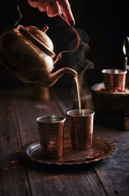 Image showing a hand pouring tea into cups.