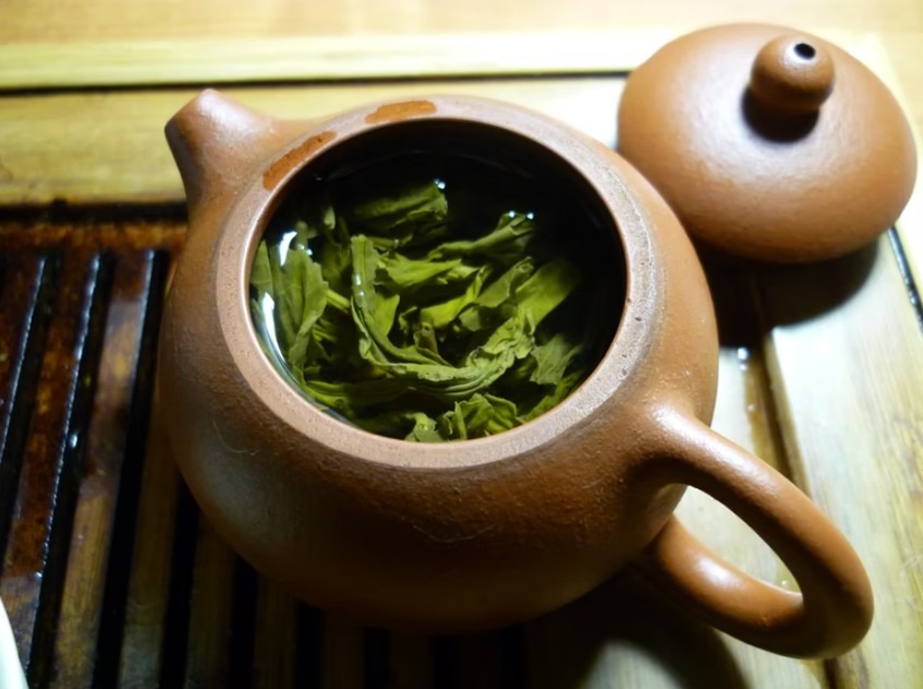 Image showing tea leaves in a pot filled with water.
