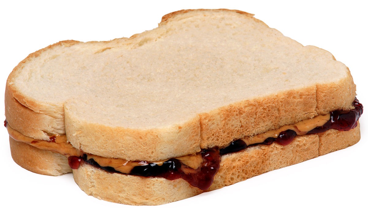 A peanut butter and jelly sandwich, made with skippy peanut butter and welch’s grape jelly on white bread