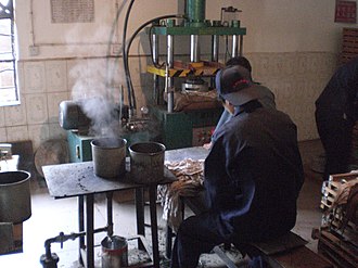 A pu-erh tea factory, which steams, bags, and presses the loose leaf pu-erh into tea bricks