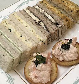 Finger sandwiches, egg, cheese, curried chicken, with shrimp canapes served during tea at the Savoy in London