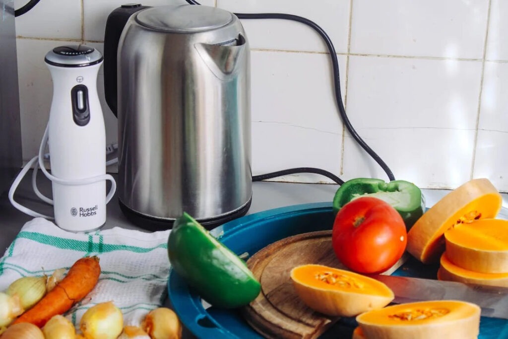 Gray Metal Electric Kettle Near Sliced Vegetables